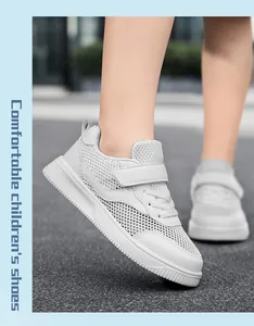 Detailed side view of breathable white mesh sneakers for kids worn by a child outdoors.