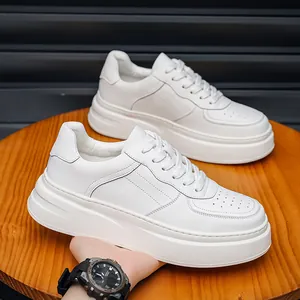 Close-up detail of stylish white leather platform sneakers for men on wooden stool