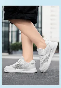 Detailed side view of children's white breathable mesh sneakers with velcro straps for summer