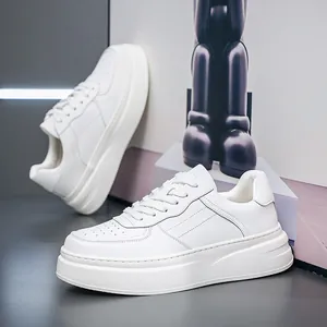 Detailed side view of men's premium white leather sneakers with breathable holes and thick soles