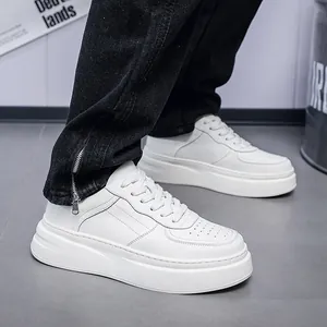 Detailed shot of men's white leather platform sneakers with breathable perforations.