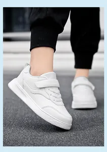 Detail shot of kids' white casual board shoes worn outdoors for school performances
