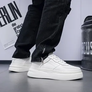 Side view of white leather platform sneakers for men with breathable design.