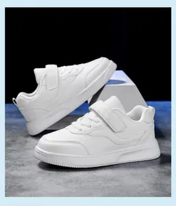 Detailed view of white children's sneakers with velcro straps for school or sports