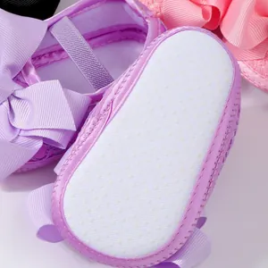 Lavendelfarbene Lauflernschuhe für Mädchen mit großer Schleife und weicher Sohle