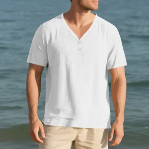 Detail view of a men's white linen-like slub fabric Henley shirt in a beach setting.