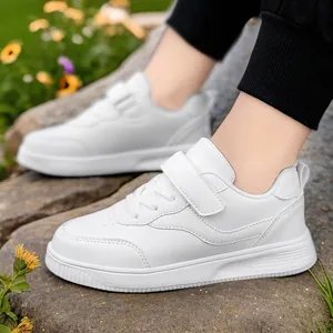 White breathable children's sneakers for boys and girls shown in an outdoor lifestyle setting