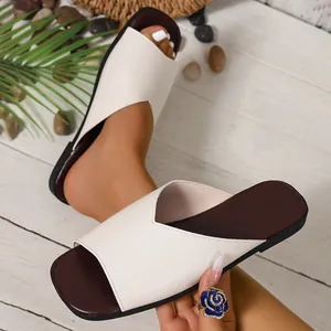 Detail of white French V-mouth leather flat slide sandals for women with square toe.