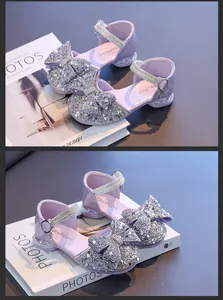 Close-up of girls' purple princess sandals with sparkling rhinestone bow details