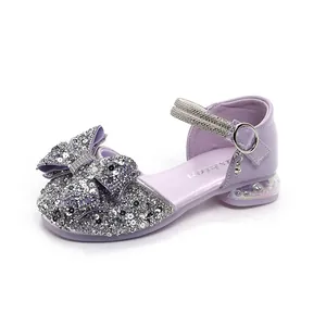 Elegant purple girls sandals featuring a sequined bow and sparkling rhinestone straps