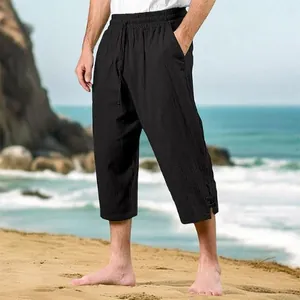 Casual men's black cotton linen beach pants with drawstring and elastic waist at beach