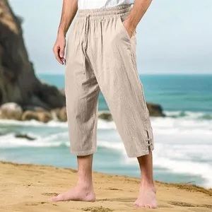 Close-up detail of beige cotton linen cropped beach pants with a drawstring waist