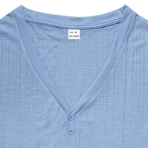 Detailed close-up of a light blue men's Henley T-shirt showing fabric texture