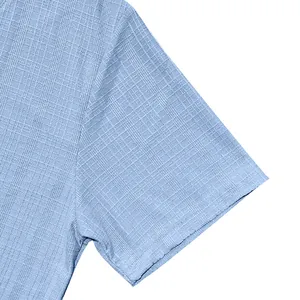Detailed macro shot of light blue slub fabric on a casual men's short-sleeve Henley shirt