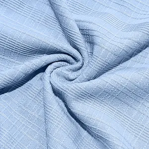 Close-up detail of light blue linen-like slub knit fabric for breathable Henley T-shirt