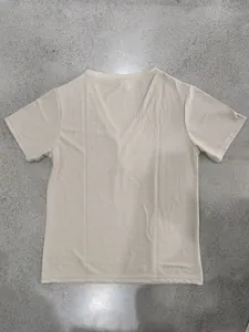 Close-up view of the back of a beige men's slub texture linen-like short sleeve T-shirt