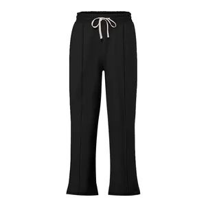 Detail view of black high street hip hop sweatpants with white drawstring and piping