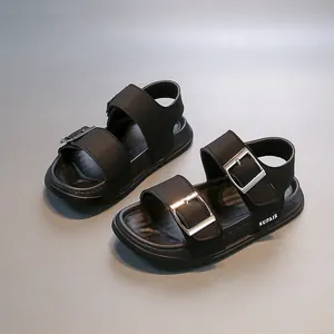 Detail of black children's sandals featuring adjustable double silver buckles.