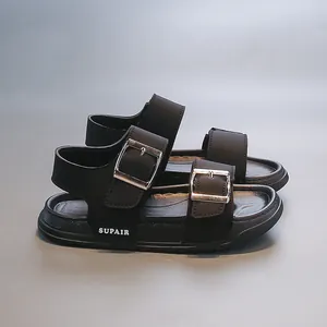 Close-up of black children's sandals featuring double buckle straps and sturdy sole