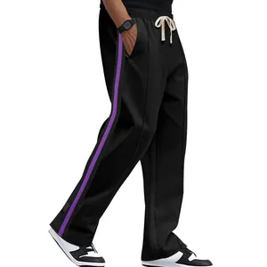 Detail of men's black flare sweatpants featuring a vibrant purple side stripe design