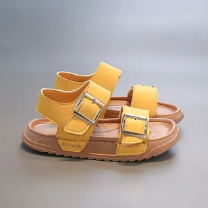 Detailed side view of yellow children's open-toe sandals with adjustable buckle straps