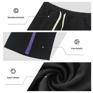 Close-up details of black men's flared sweatpants with purple side stripes