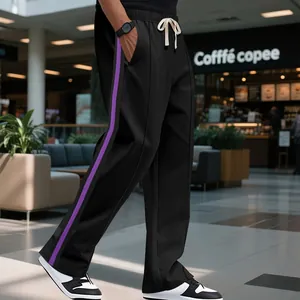 Detailed view of men's high-street flared sweatpants with purple side stripes