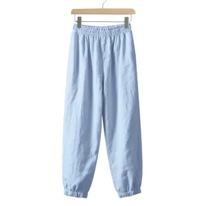 Detailed view of light blue linen joggers showing elastic waistband and fabric