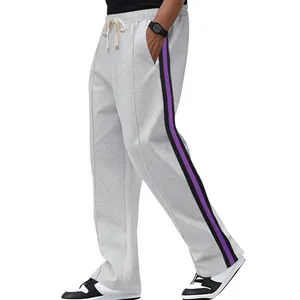 Detail of grey men's sweatpants featuring purple and black side stripes and a flared leg