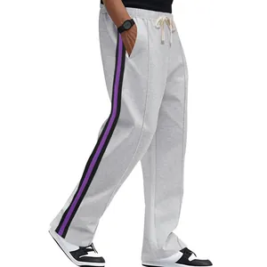 Detailed close-up of men's flared sweatpants featuring purple and black side stripes