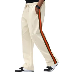 Detail of cream flared sweatpants with side contrast stripes and drawstring waist.