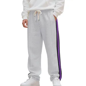 Detail view of men's grey sweatpants with purple side stripes and drawstring waist