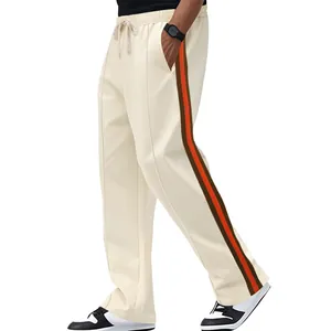 Detailed side view of off-white flared sweatpants with orange and brown stripes.