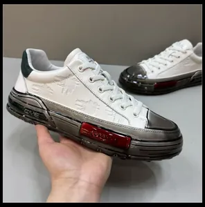 Detailed view of white leather sneaker with chunky translucent sole and red accent