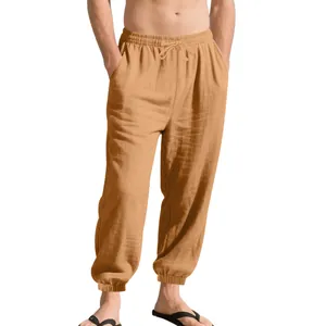 Close-up of men's light brown linen joggers with drawstring waist and elastic cuffs
