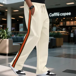 Side view detail of men's cream flared sweatpants with vintage orange and brown side stripes