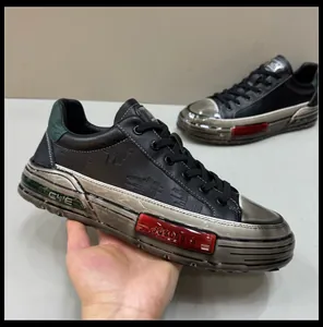 Macro view of stylish men's black leather sneakers featuring metallic textured soles