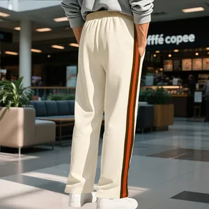 Men's off-white flare sweatpants with jacquard contrast side stripes in lifestyle mall setting