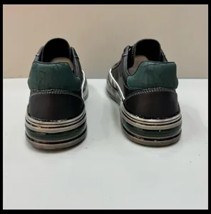 Rear view of men's casual leather sneakers with thick layered sole and green textured heel