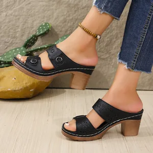 Close-up of black PU wedge sandals with hollowed-out straps and decorative buttons