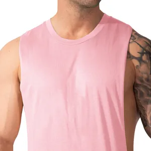 Detail view of a men's pink fitness tank top with wide armholes and breathable fabric