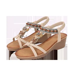 Detailed view of beige bohemian wedge sandals with colorful beads and rhinestones