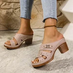 Detailed view of nude peep-toe platform mules with elegant cutout patterns and block heels