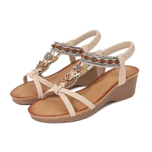 Detailed view of bohemian wedge sandals with intricate rhinestone and bead decor