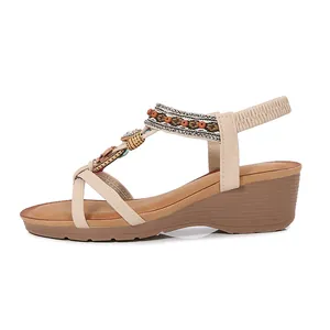 Elegant side profile of bohemian wedge sandals with intricate rhinestone and bead details