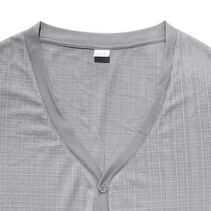 Close-up detail of gray slub linen texture and buttoned V-neckline on men's Henry shirt