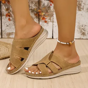 Side view of women's khaki wedge sandals with perforated cross straps for summer