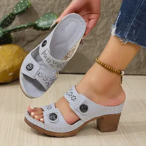 Detailed view of light blue hollow-out PU wedge sandals with heart patterns and metallic buckles