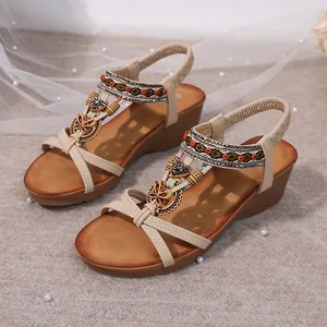 Detailed view of bohemian wedge sandals with beaded rhinestones and ethnic pattern.