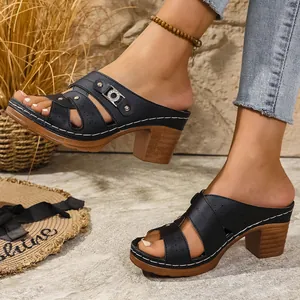 Detail of black platform peep-toe slippers with wood-grain high heels